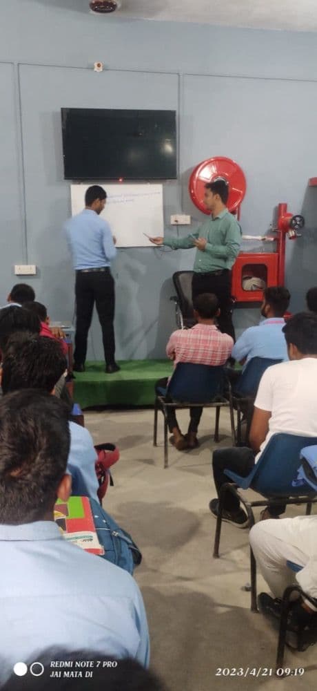 Trainers explaining fire safety on the whiteboard